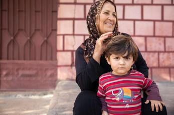 An adult sitting with a child.