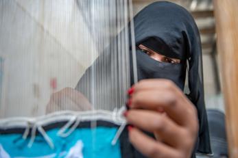 A person operating a loom.