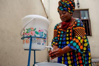 A person washing their hands.