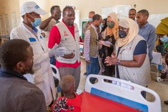 Mercy corps ceo tjada d’oyen mckenna at a local hospital meeting children and adults suffering from malnutrition.