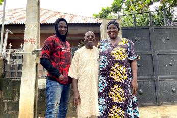 Three people standing together for a group photo.