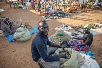 The vice chairperson of ala-zabu savings group attends to his silver fish business that he co-owns.