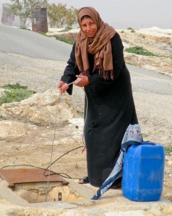 A woman getting water from a catchment system