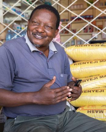 Peter sits in a chair at his agricultural supply store