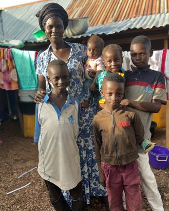 A mother and her children standing outside