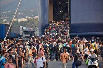 Refugees board the daily ferry from the island of Lesbos to Athens, Greece. Those who can't make it onboard must wait another day for the next ferry. Photo: Graham Niven/Mercy Corps