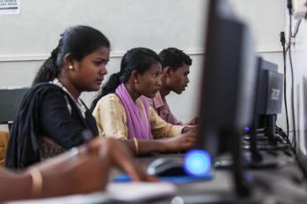 Three people seated at computers