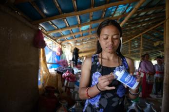 Radhika holding water purification liquid