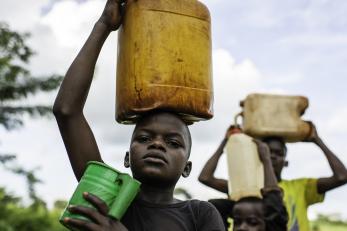 Boys carrying water