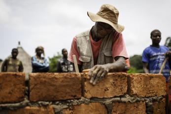 A man building a brick wall