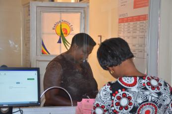 Customer transacting at the counter of Rukiga SACCO