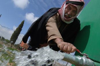Man at water tap in Jordan