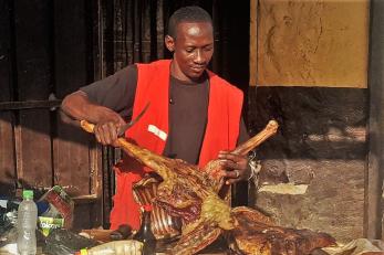 Djingaré slicing some meat