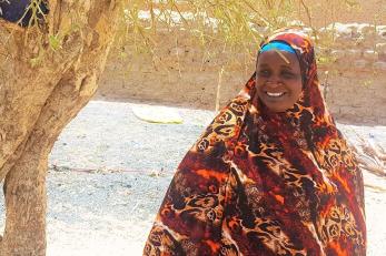 A woman in a red and orange scarf