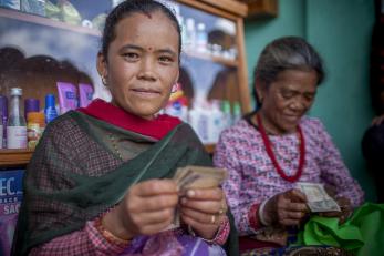 Two women handling money in a shop