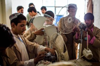 Men working in Afghanistan repairing fans