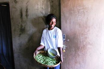 Beauty Jokonya, a local farmer in Zimbabwe's Murehwa district, with bounty from her crop field — which, with help from Mercy Corps, she and her husband irrigate with a treadle pump.