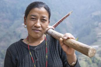 Woman with tool over her shoulder