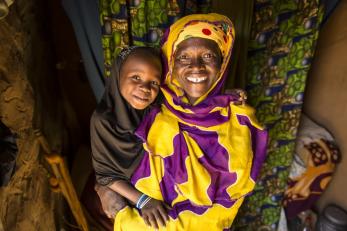 Hawa, a single mother in Niger, must find new ways to feed herself, her daughter Ramatou and her goats when drought hits. Photo: Sean Sheridan for Mercy Corps