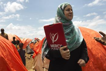 Mercy Corps employee in Somalia, holding clipboard