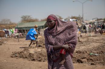 A woman and her child, displaced by the conflict, at one of South Sudan's many crowded displacement camps. Photo: Camille Lepage for Mercy Corps