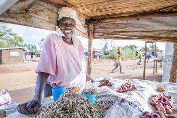 Smiling woman at market stand