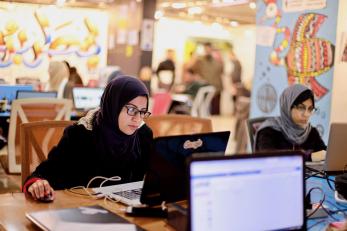 Woman operating a computer.