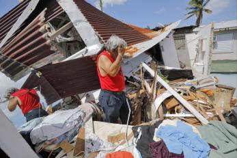 Man among Hurricane Maria rubble