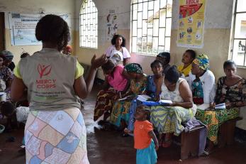 mercy corps team member speaking to group of people