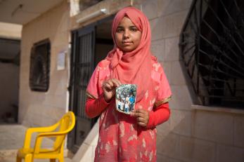 A girl holding a worn photograph