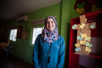 A woman in a blue coat and floral scarf