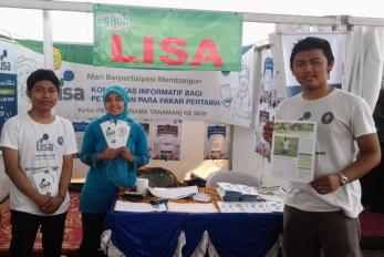 young people standing at a booth