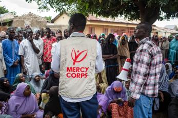 mercy corps team member facilitating a community meeting