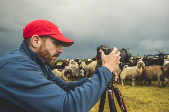 Ezra Millstein, senior content producer, captures Mercy Corps’ impact on people and communities with his camera. Here, he photographs herders in Altan-Ovoo, Mongolia, working with us to keep their cattle, sheep and other animals free of insects and disease. Photo: Sean Sheridan for Mercy Corps
