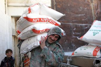 Man carrying bags of flour