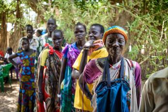 People in South Sudan wait in line for a cash distribution