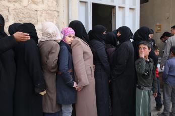 Women in line for food baskets in Syria