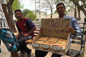 Young men on a bench selling bocadillo for 500 pesos