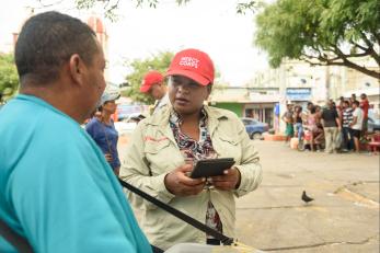 mercy corps team member interviewing man on street