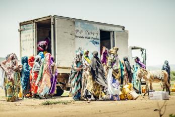 women gathering around a truck