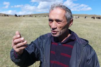 man in field speaking