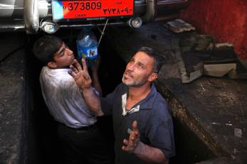 man and boy working in street