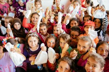 Students at Habbouch Public School in Lebanon get ready for lunchtime. They received healthy bag lunches through our lunch delivery program, which helped fight hunger in Lebanese schools that serve refugee and low-income children. Photo: Corinna Robbins/Mercy Corps