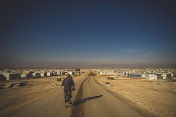 man biking down road