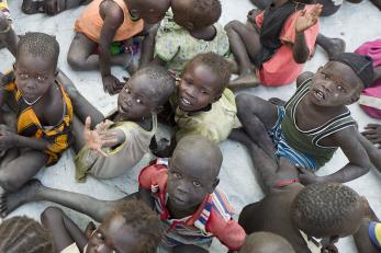 a group of children experiencing famine sitting in a group