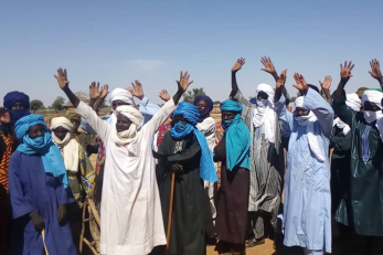 A group of people with their hands in the air.