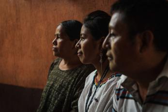 Three people sitting together.