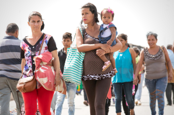 Families walking together at a border crossing.