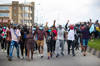 A group of protestors marching down a street.