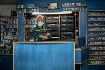 A vendor standing in a music store. 